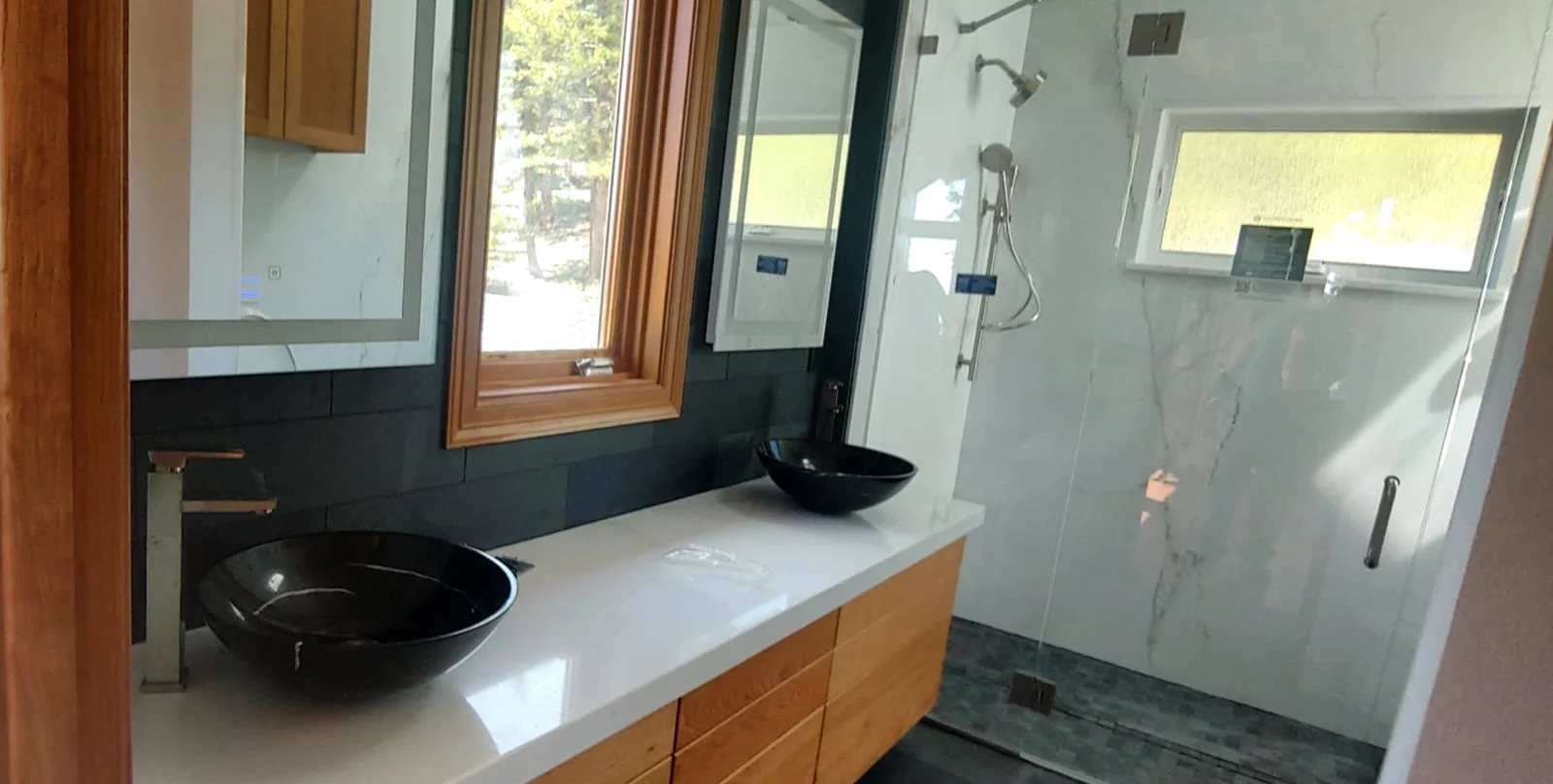 A remodeled bathroom with a double sink vanity