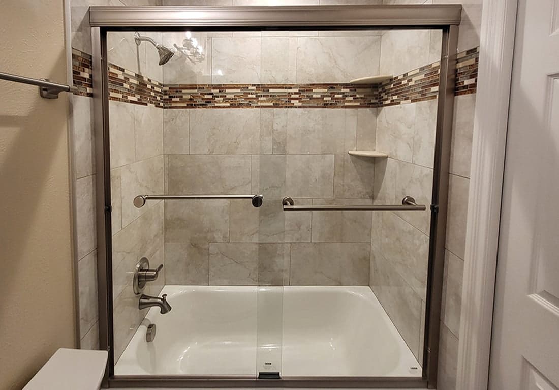 After: the same bathroom finished, with a tiled tub surround